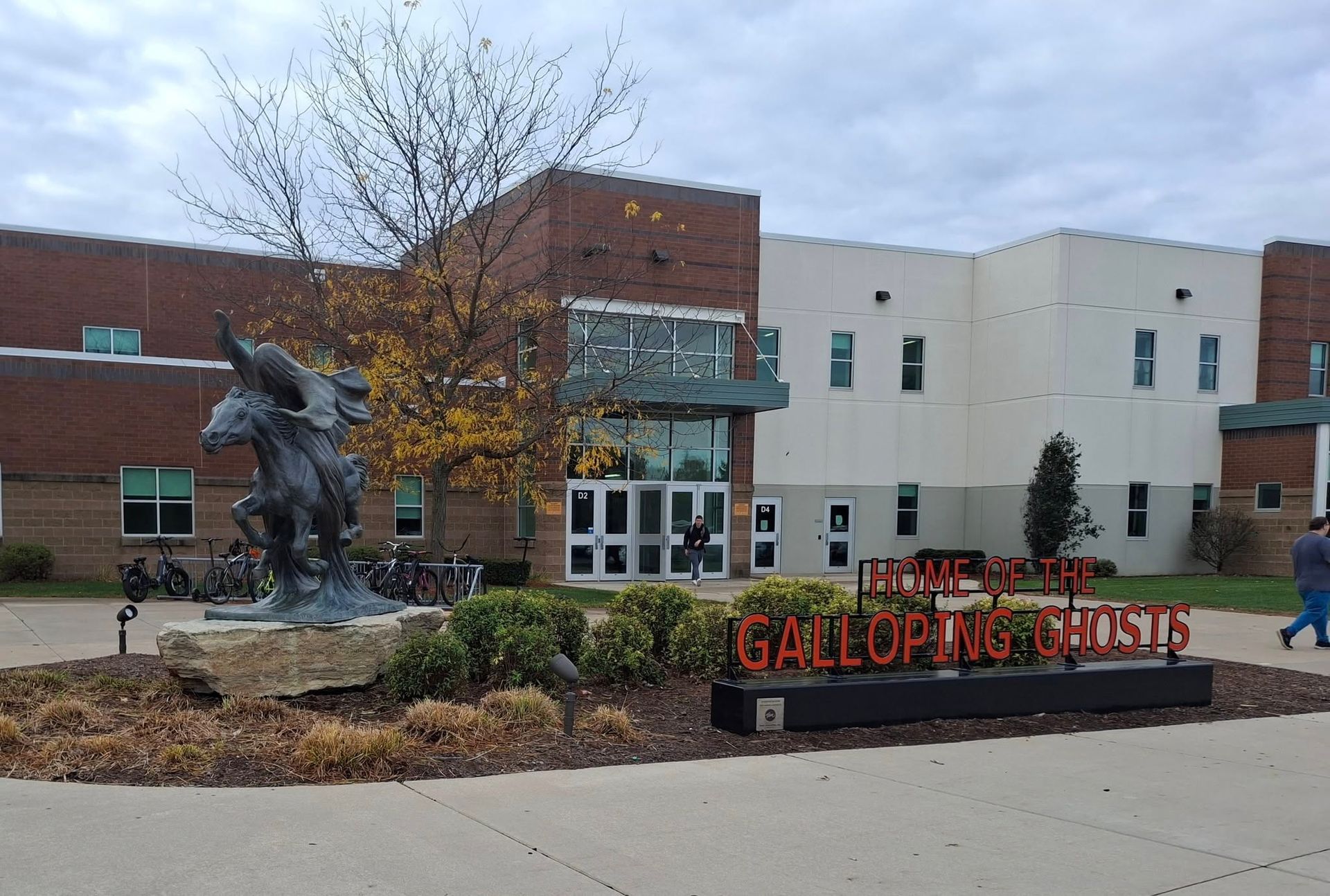 Diverse group of people with hands in a circle, teamwork concept.