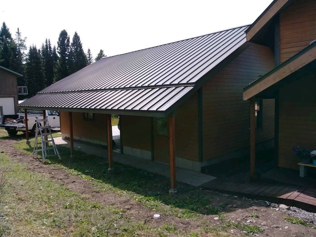 A house with a metal roof and a porch