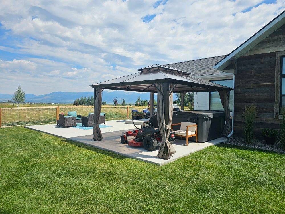 There is a gazebo in the backyard of a house.