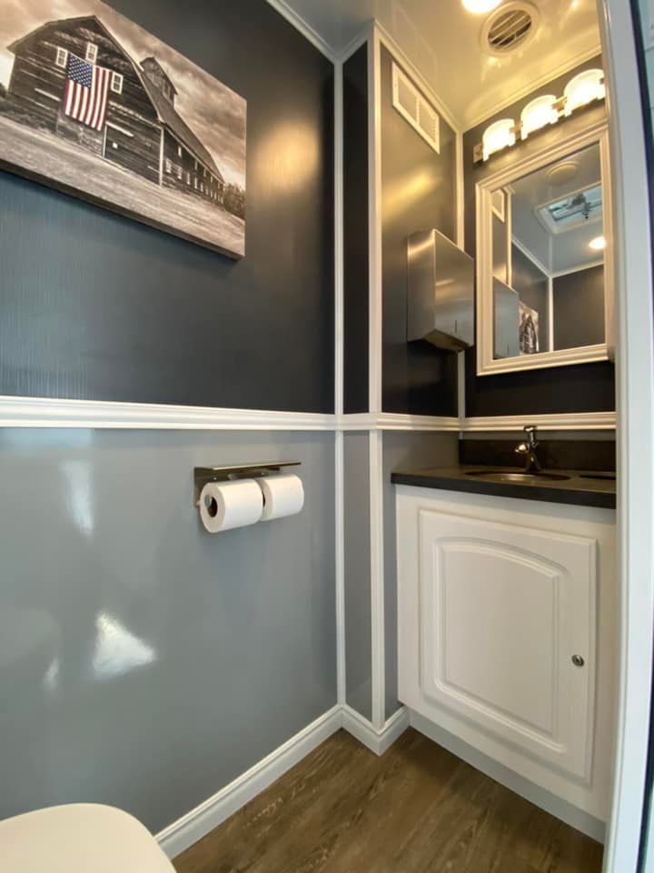 Interior view of a bathroom with wooden details, showcasing luxury restroom trailer rentals.