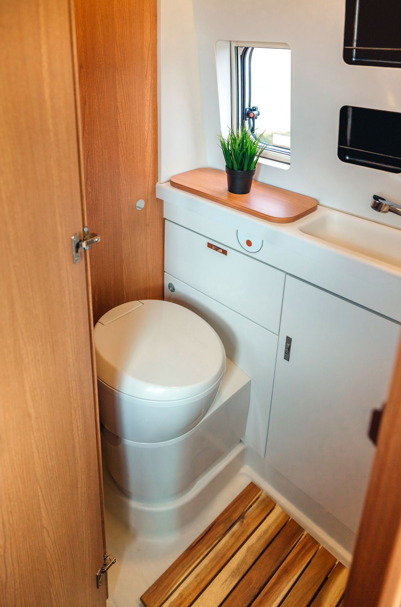 Interior view of a bathroom with wooden details, showcasing luxury restroom trailer rentals. Interior view of a bathroom with wooden details, showcasing luxury restroom trailer rentals.