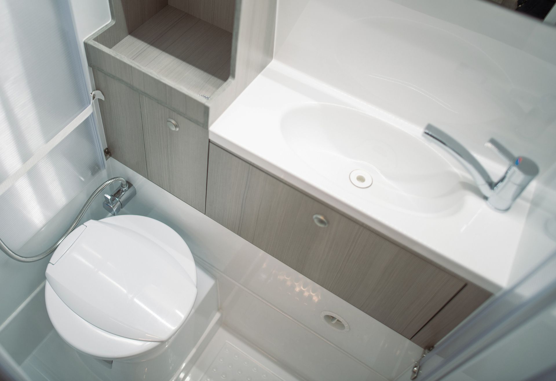Interior view of a modern and elegant bathroom, showcasing luxury restroom trailer rentals. Interior view of a modern and elegant bathroom, showcasing luxury restroom trailer rentals.