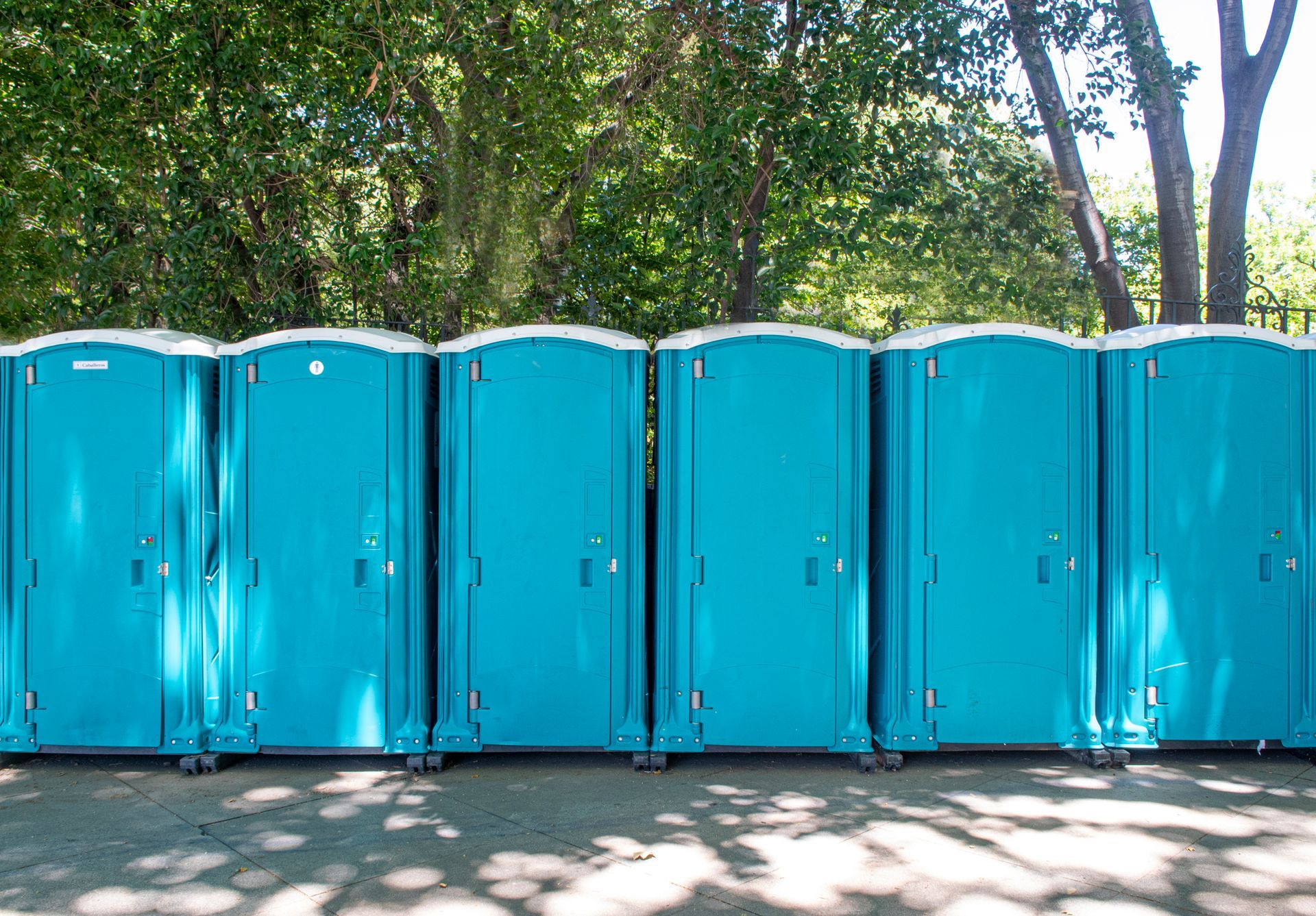 A row of luxury restroom rentals outdoors.
