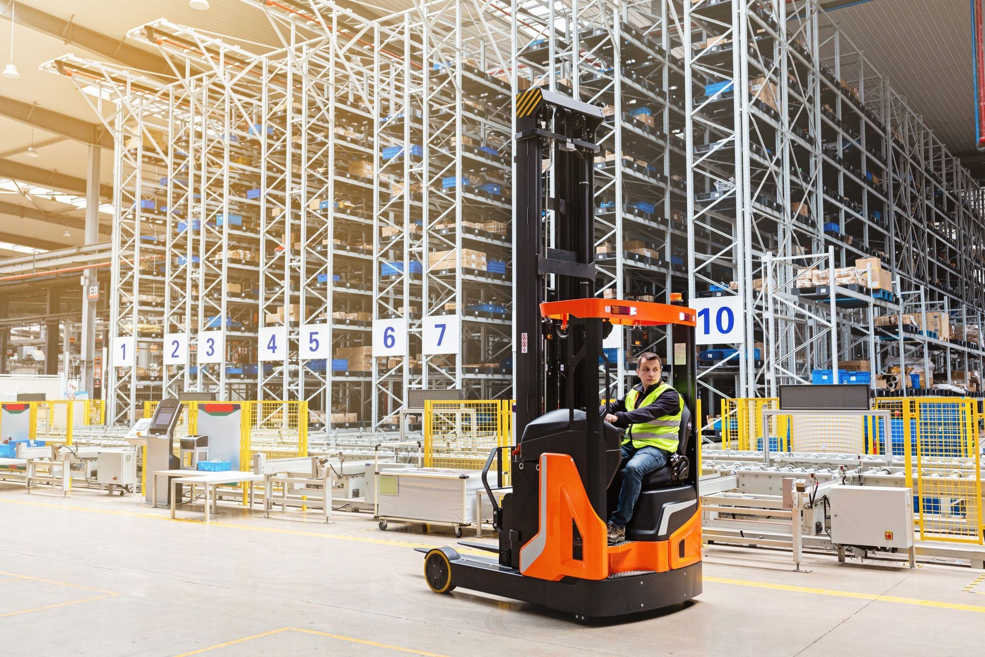 A man is driving a reachtruck in a warehouse.