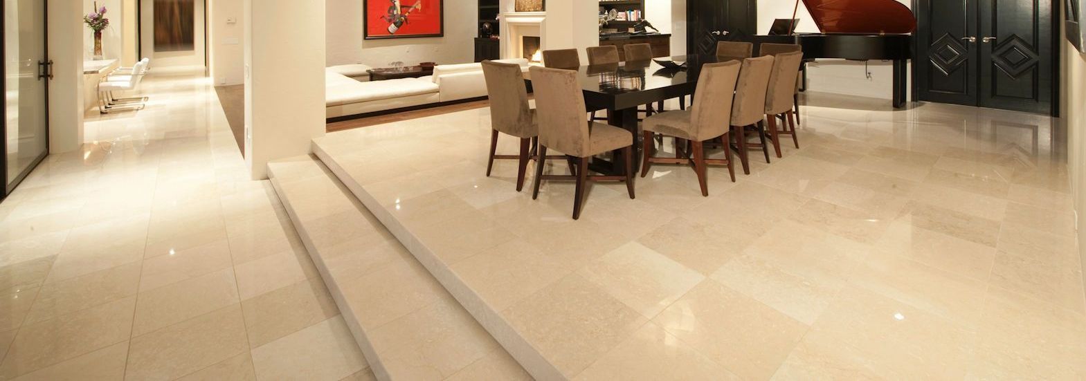 Spacious, modern interior with tiled floors, dining table, and piano.