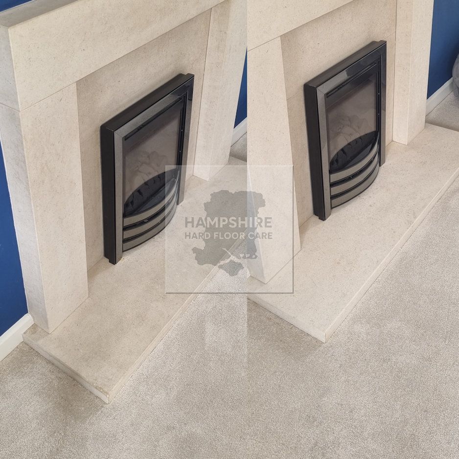 Two beige stone fireplaces with black fire inserts, on a light-colored carpet against a blue wall.