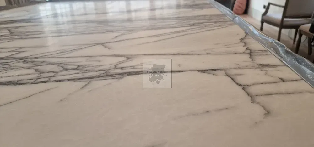 White marble table with gray veining.
