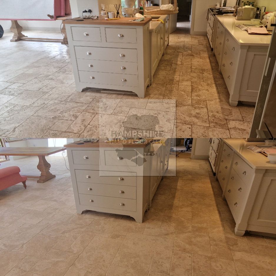 Kitchen with light cabinets, wooden countertops, and tiled floor.