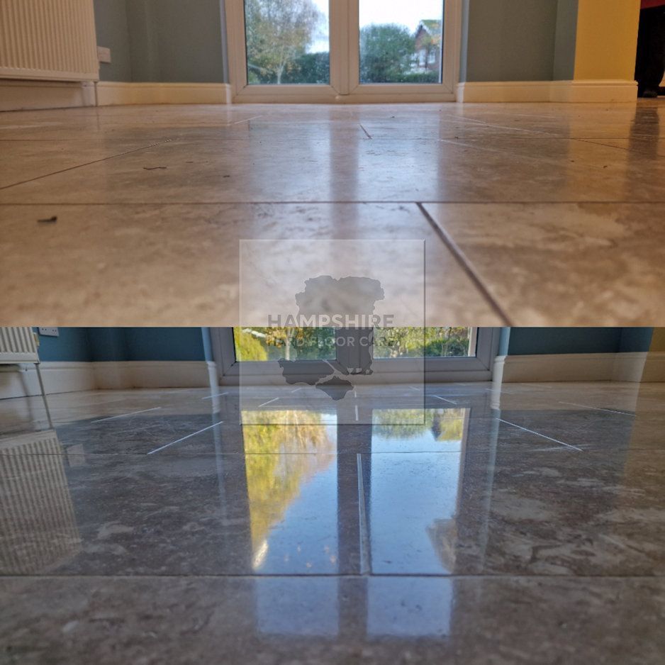 Comparison of dull and polished marble floor tiles reflecting a window and outdoor scenery.