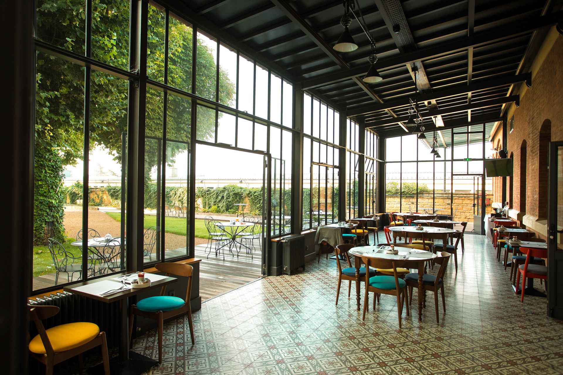 A room filled with lots of potted plants and a chair.