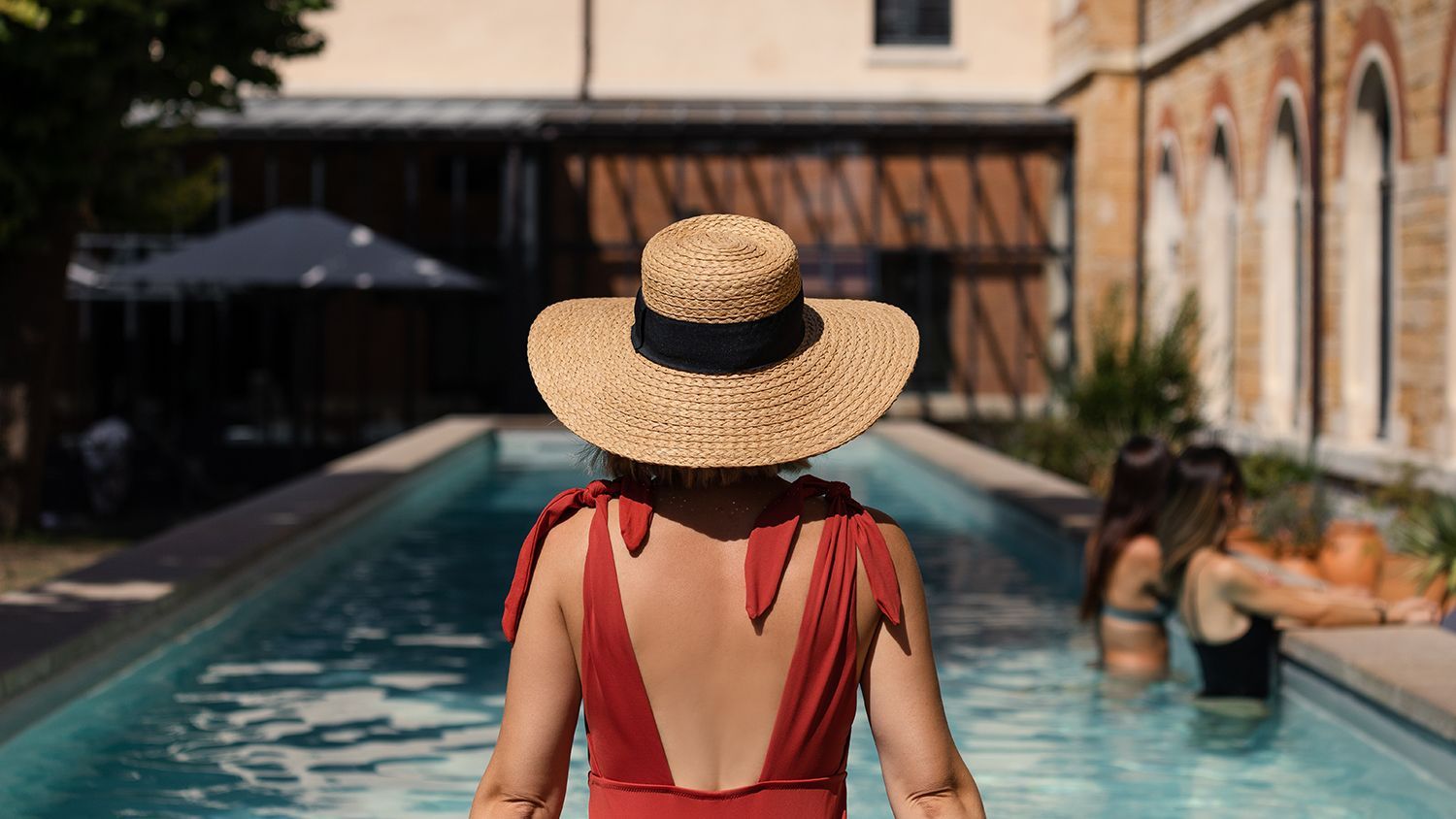 A dining room with a long wooden table and chairs.