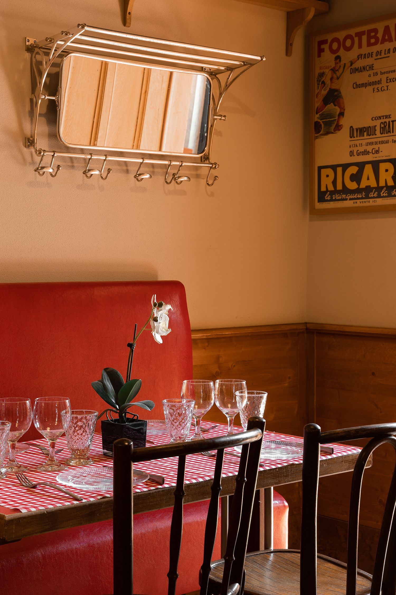 A bathroom with a sink , bathtub , mirror and chair.