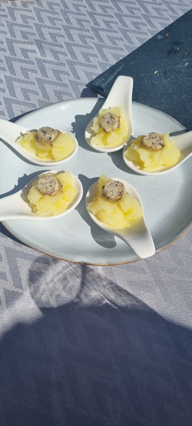 A plate of food with spoons on it on a table.