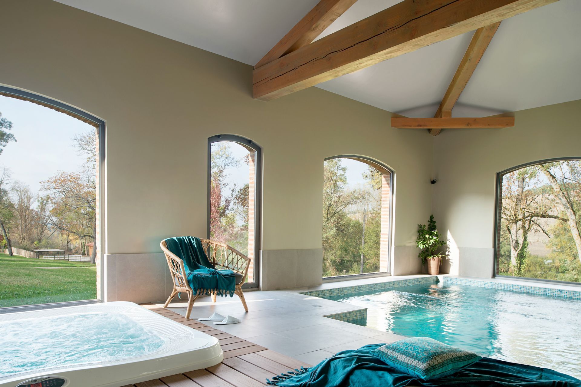 A bathroom with a sink , bathtub , mirror and chair.