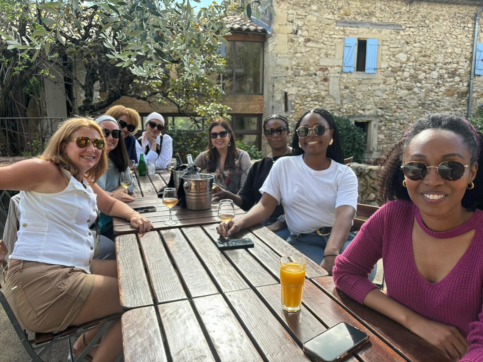 A group of women are sitting at a table with drinks.
