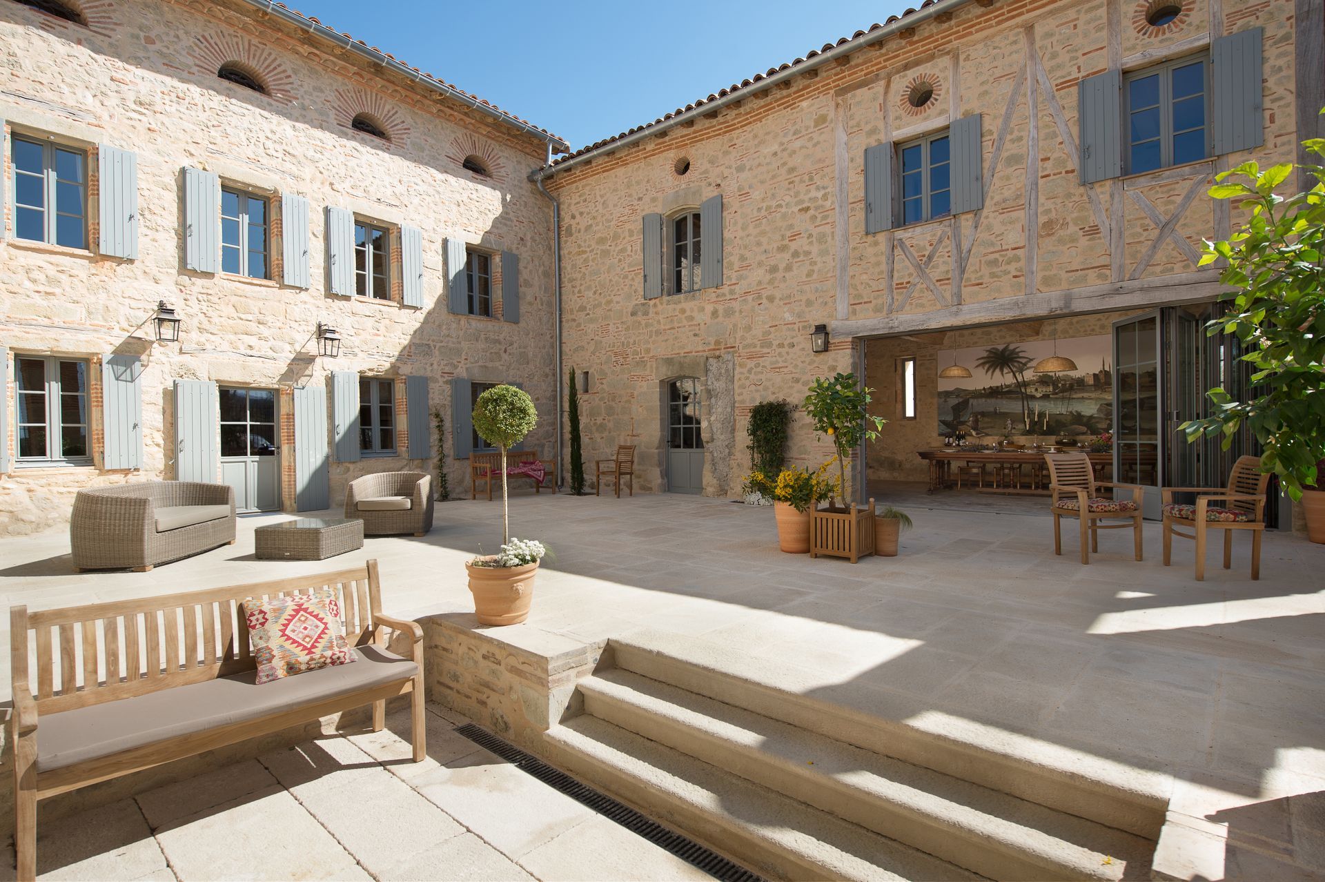 A bedroom with a large bed and a painting on the wall.
