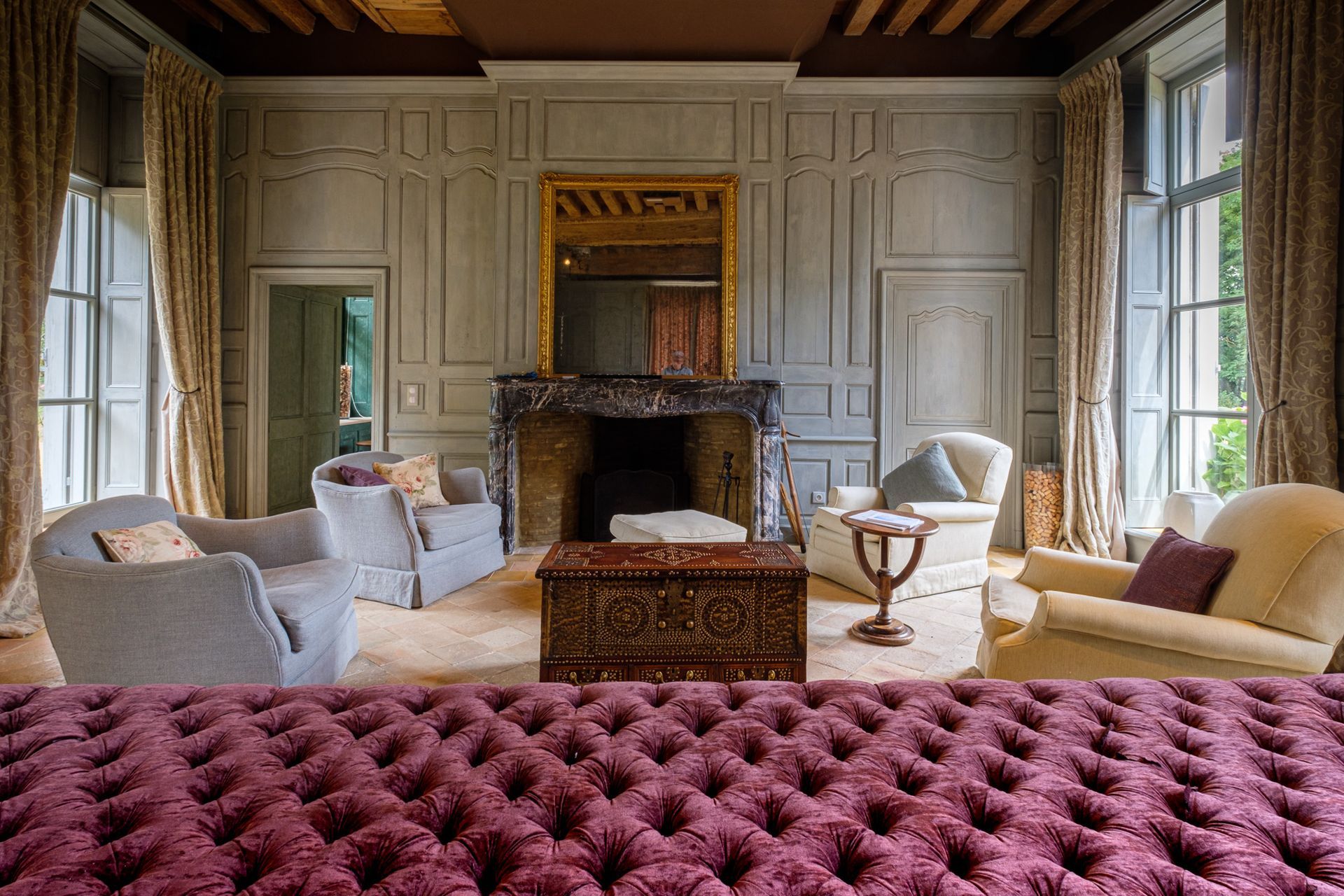 A bedroom with a large bed and a painting on the wall.