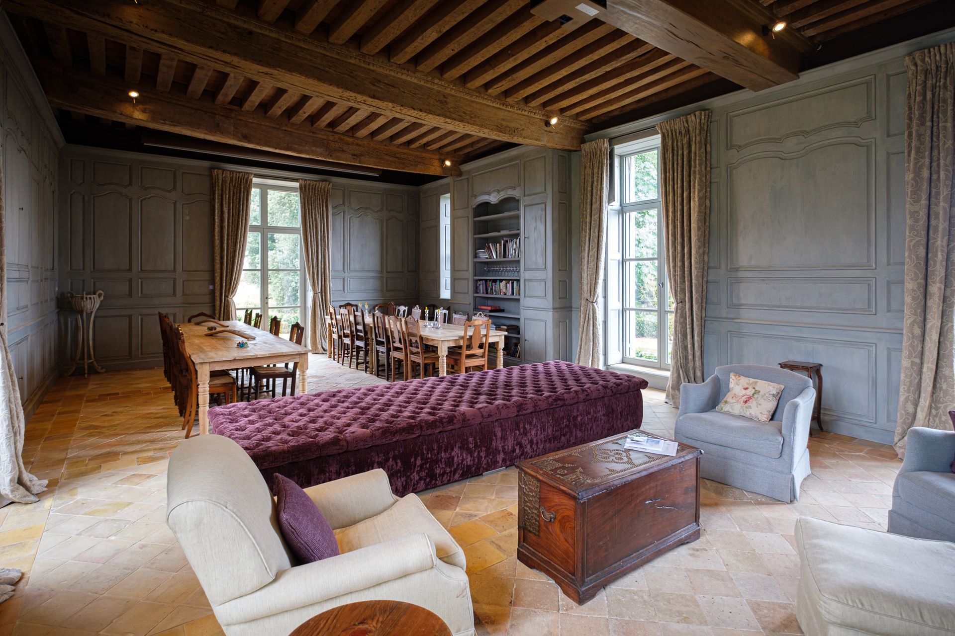 A dining room with a table and chairs and a fireplace.