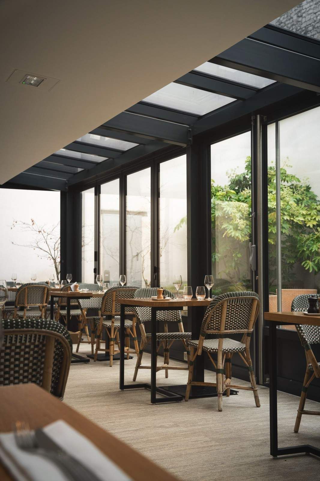A bedroom with red walls , a large bed , a desk and a fireplace.