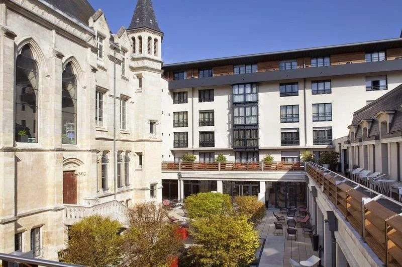 A room filled with lots of potted plants and a chair.