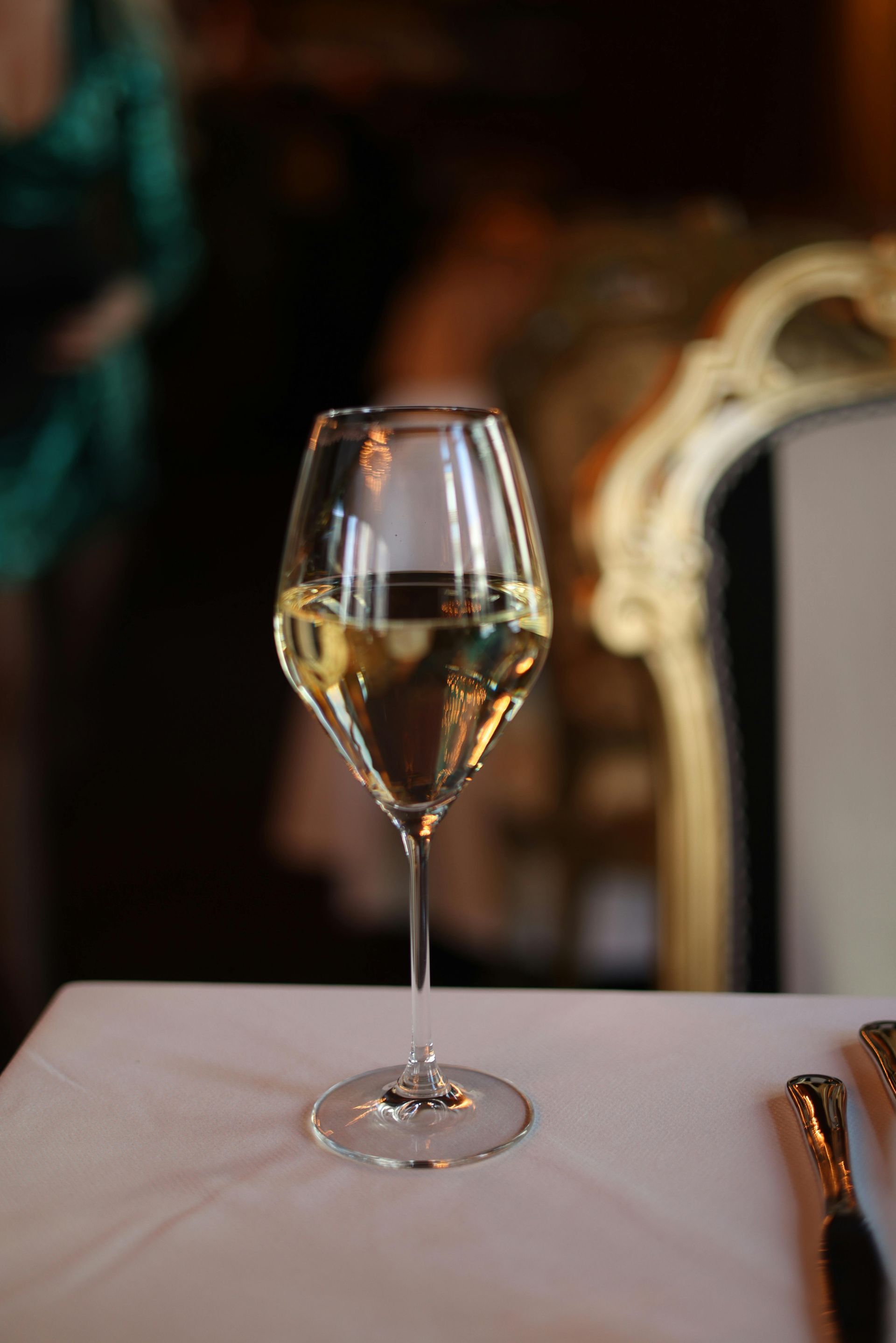 A bathroom with a sink , bathtub , mirror and chair.