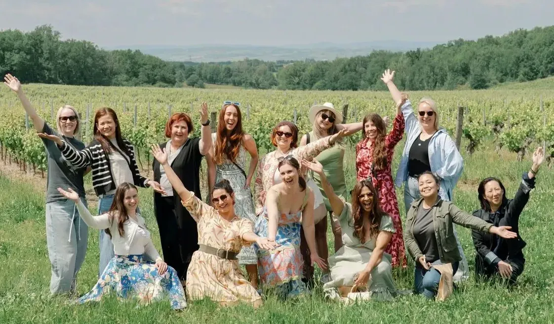 A pink building with palm trees in front of it