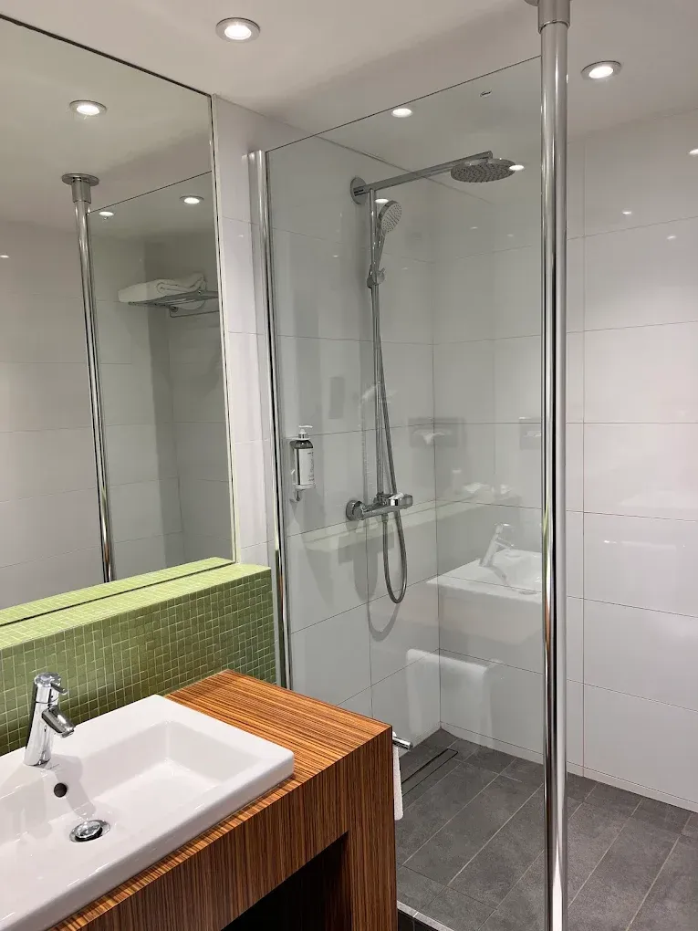 A dining room with a long wooden table and chairs.