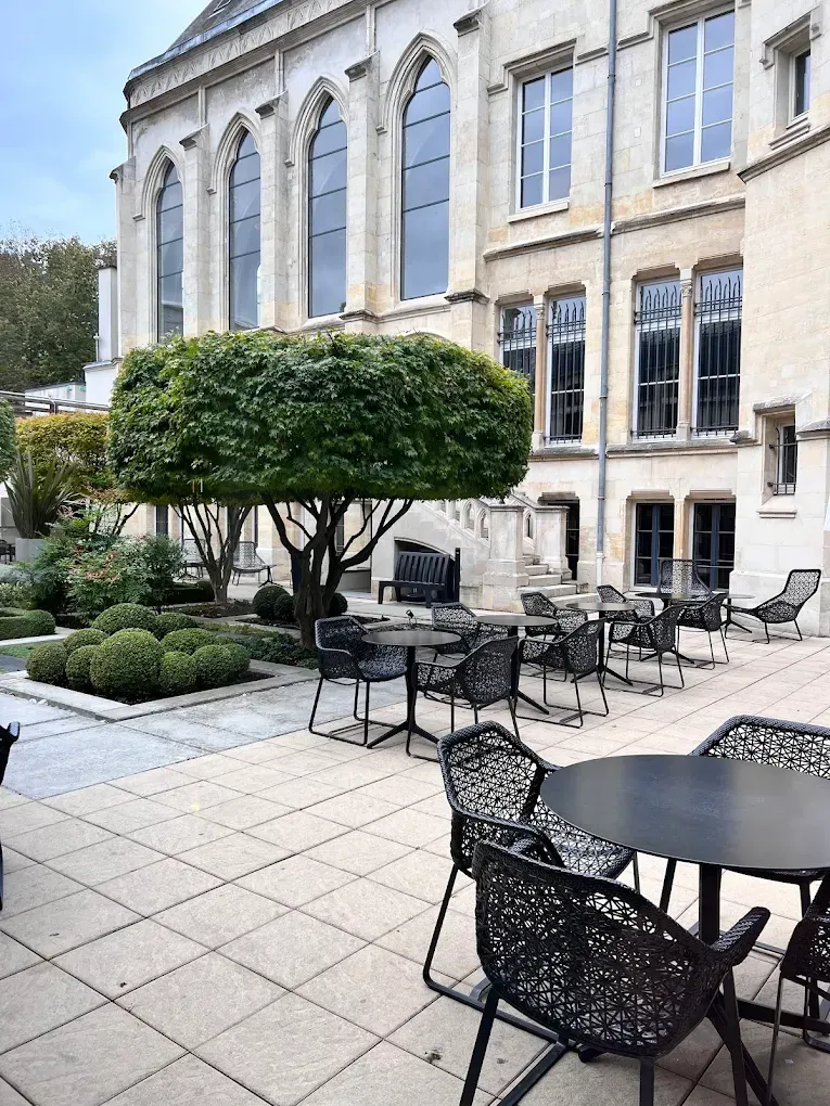 A table with a bowl of strawberries and cranberries on it.