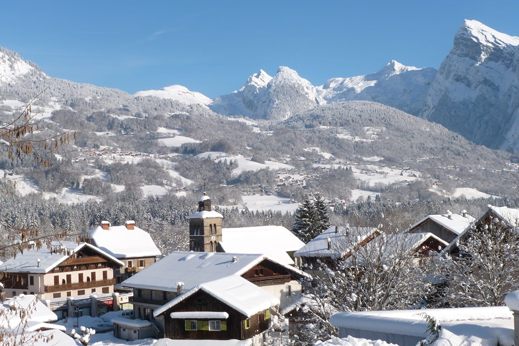A snowy village with mountains in the background
