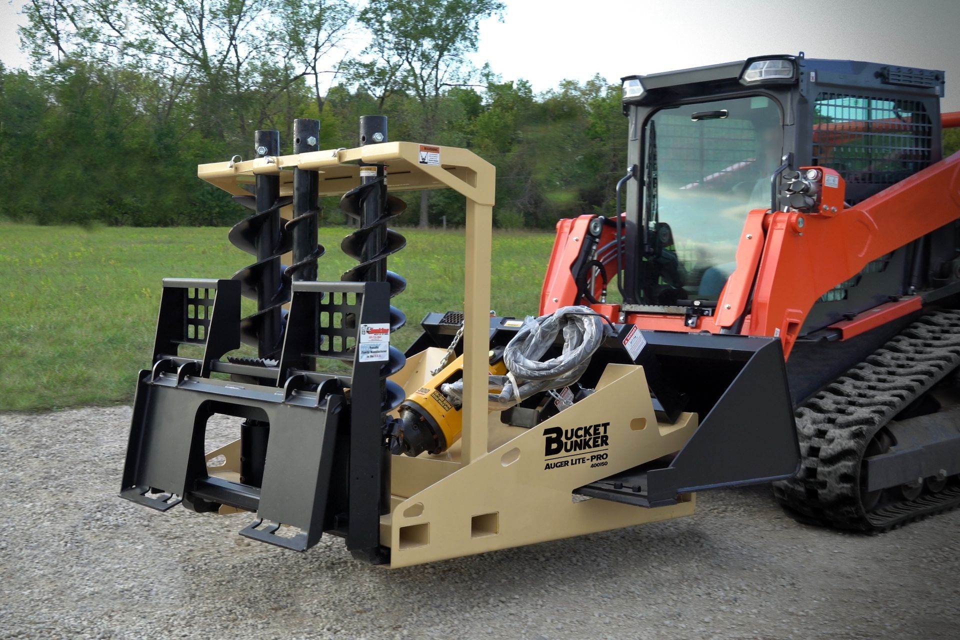 A bucket bunker auger Lite-pro is loaded with multiple attachment and attached to a Kubota skid steer.
