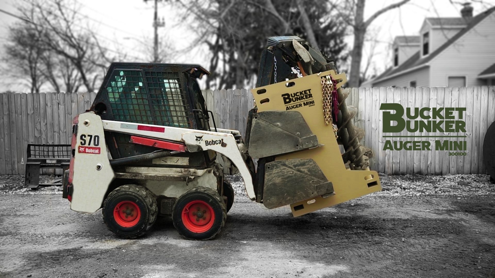A mini-skid loader with a bucket bunker rack fully loaded with attachments. 
