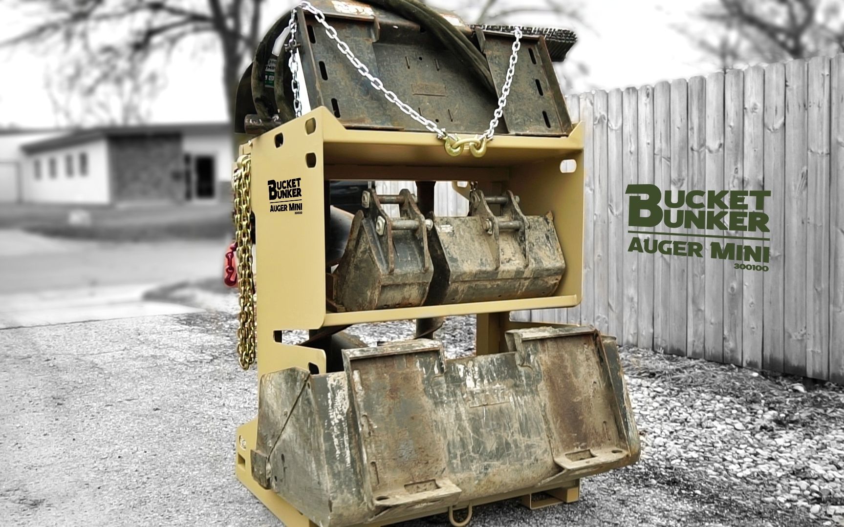 A bucket bunker is sitting in front of a wooden fence with attachments on it. 