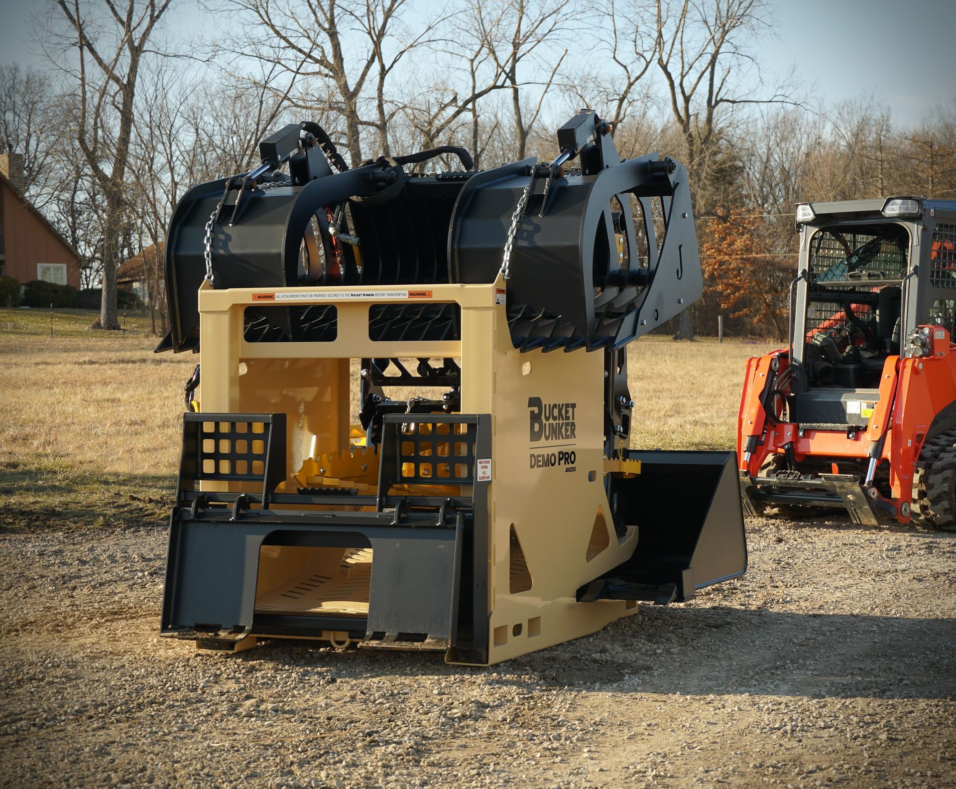 A Demo Pro Bucket Bunker® loaded with a grapple bucket, tree puller, pallet forks, and a skid steer bucket. 