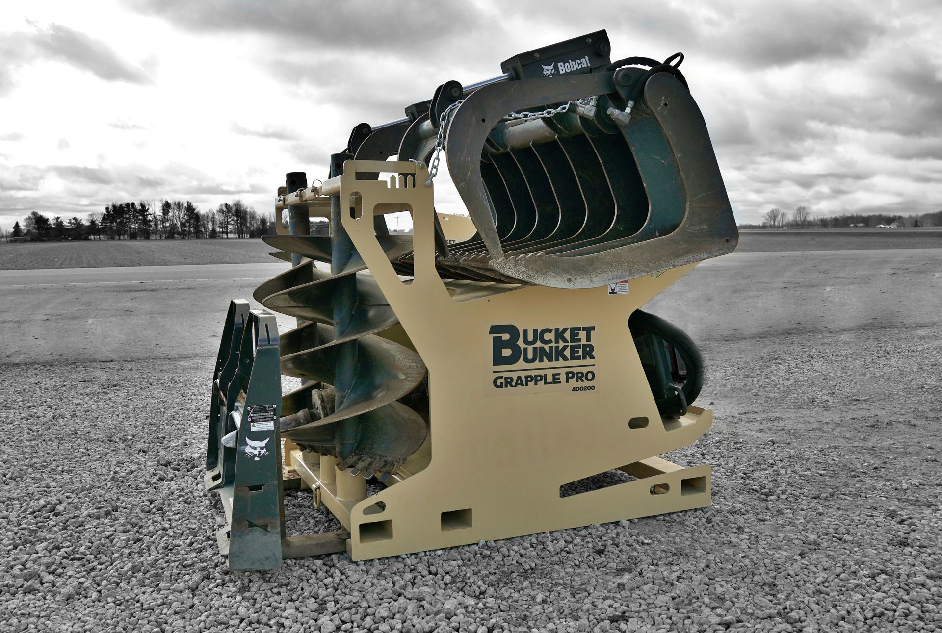 A bucket bunker is sitting on a gravel road