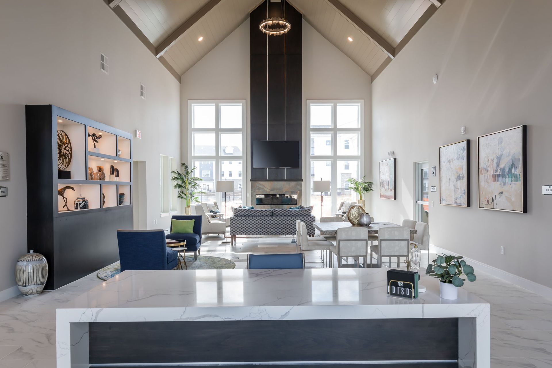 A large living room with a couch , chairs , and a fireplace.