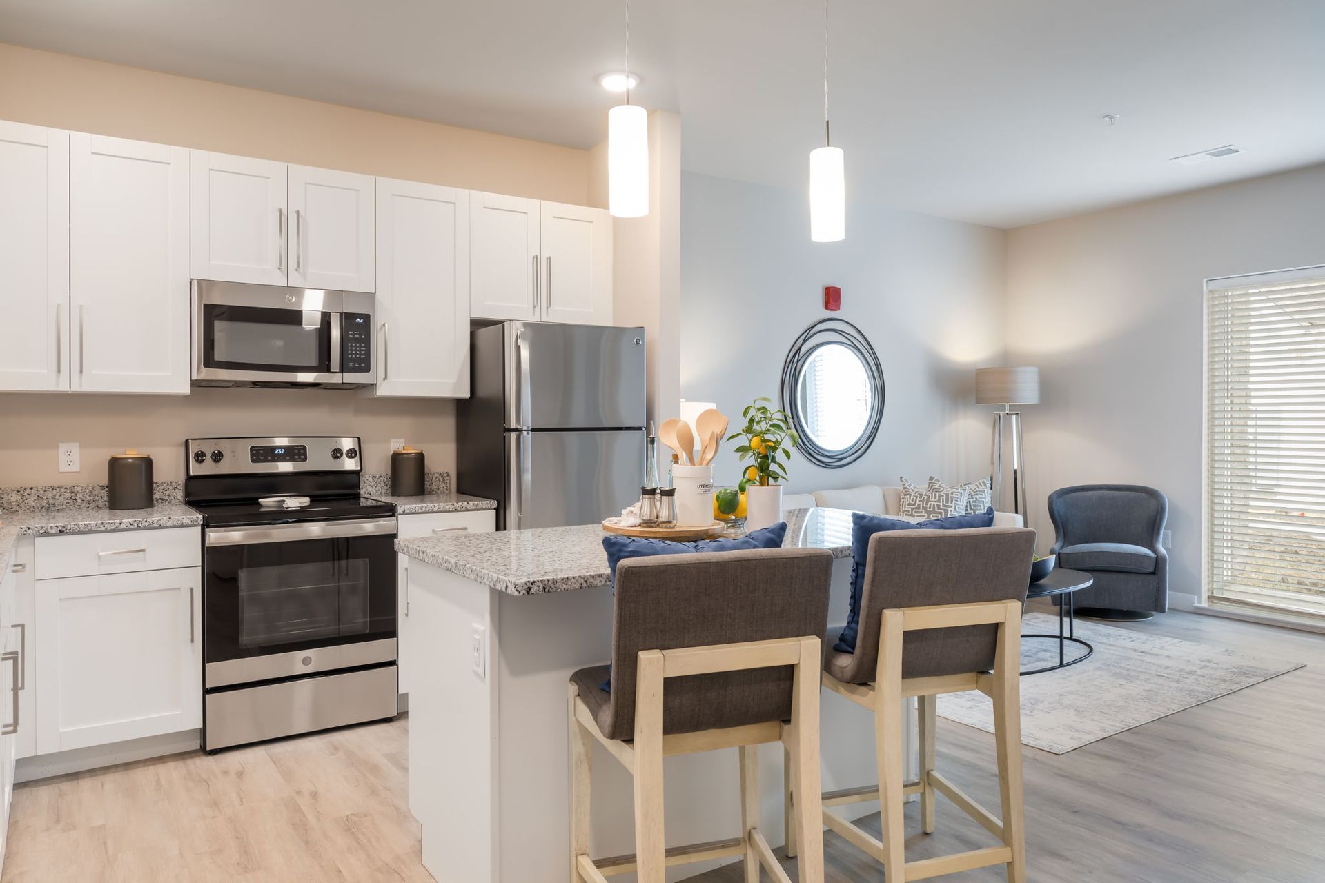 A kitchen with stainless steel appliances and white cabinets