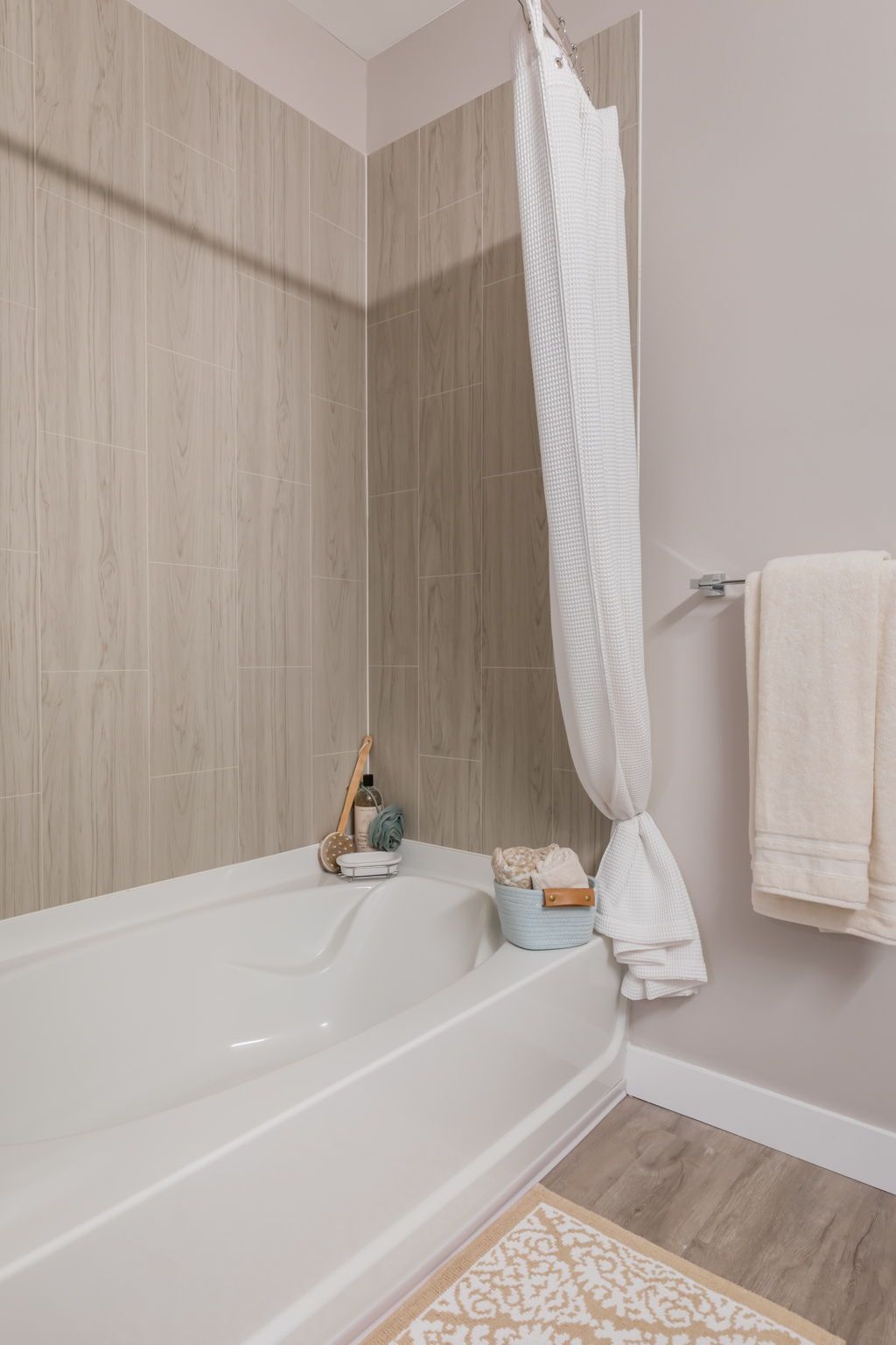 A bathroom with a bathtub and a shower curtain.