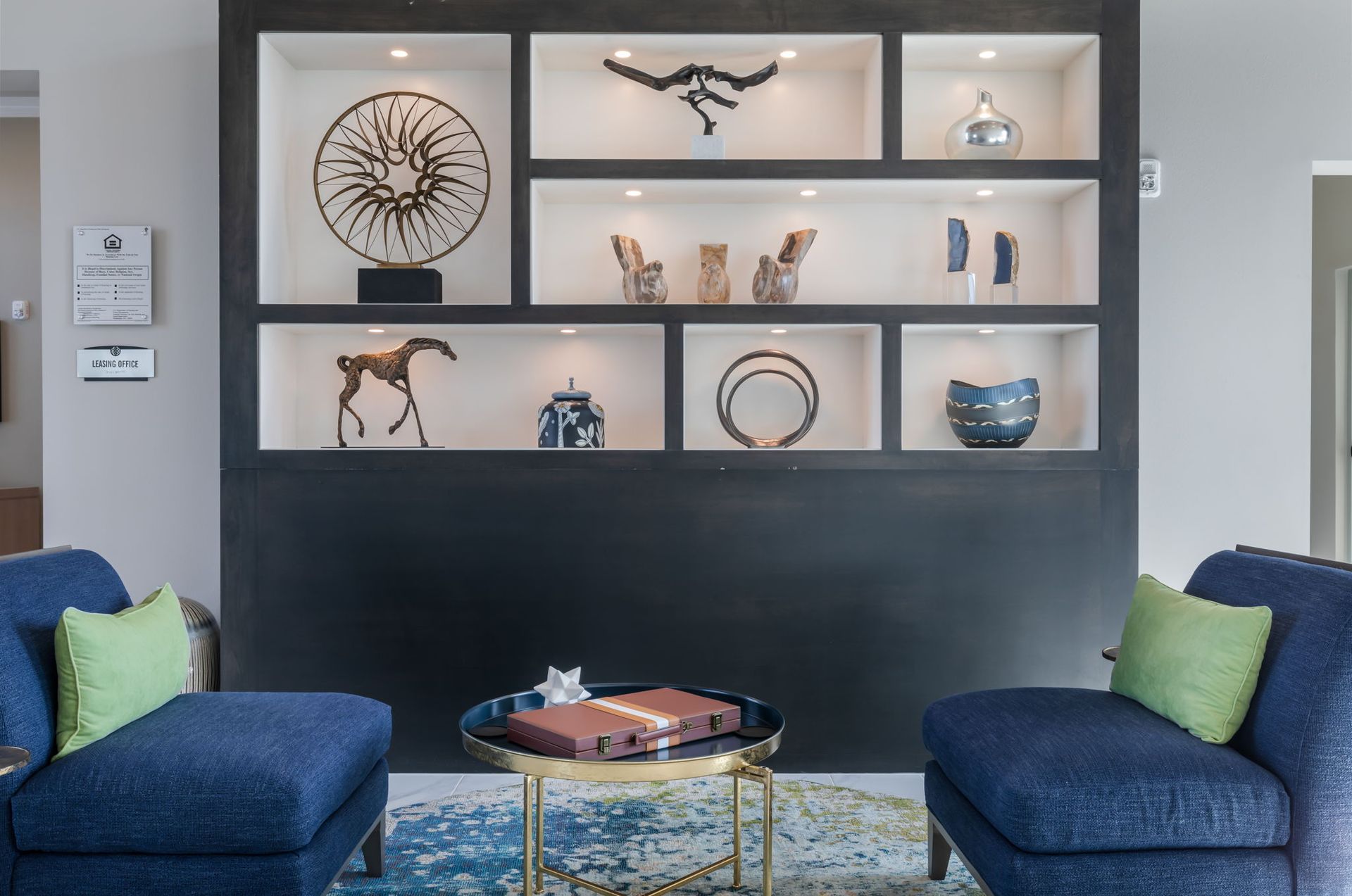 A living room with two blue chairs and a table
