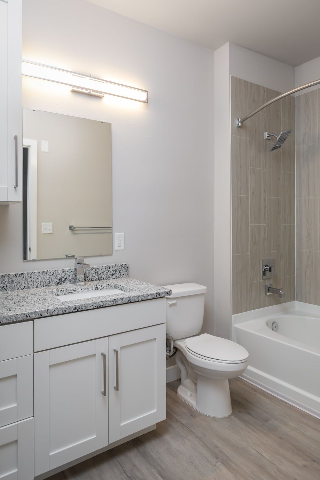A bathroom with a toilet , sink , and bathtub.