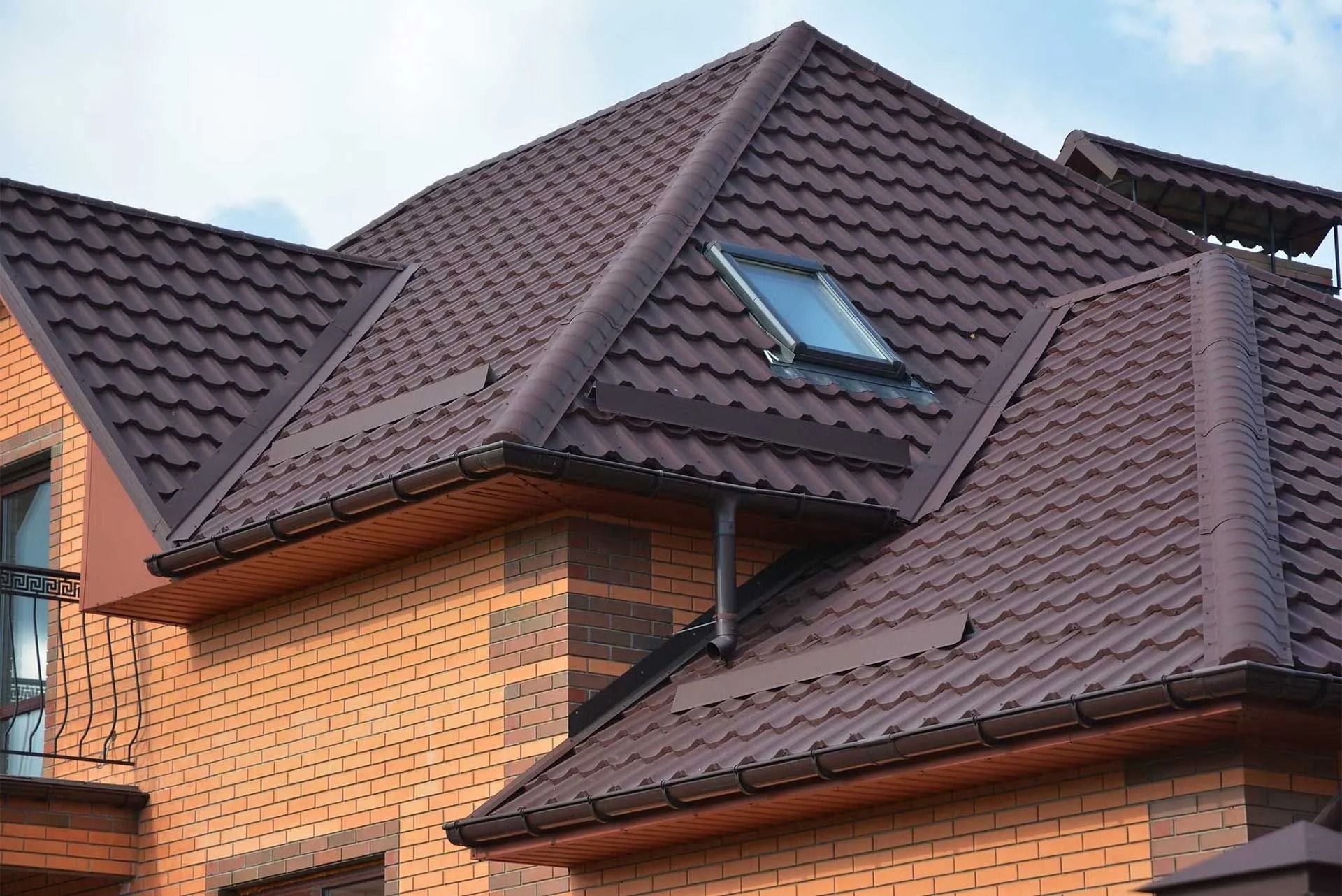 Brick houses with steep brown tiled roofs and a skylight window