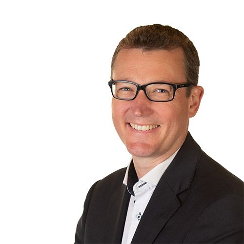 Meet the workplace investigators - Dominic is wearing a grey sweater and blue shirt is smiling for the camera .