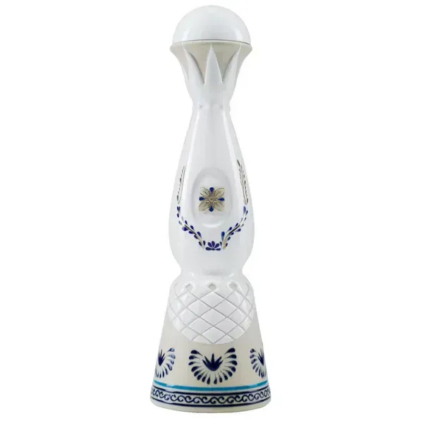 White ceramic tequila bottle with blue floral designs.