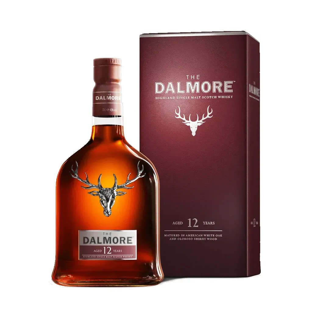 Dalmore 12 Year Old Scotch whisky bottle and maroon box, featuring a silver stag emblem, against a white backdrop.