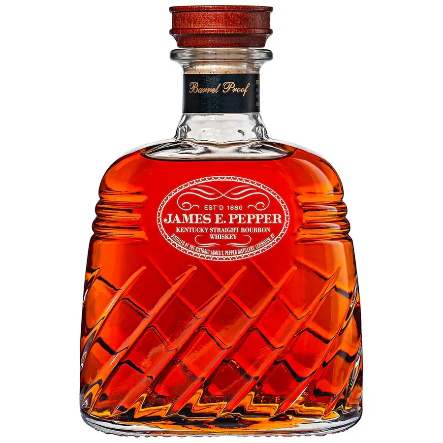 Bottle of James E. Pepper Barrel Proof Kentucky Bourbon, amber liquid in a glass bottle with decorative angled cuts.