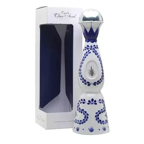 Bottle of Clase Azul tequila in a white and blue decorative bottle with silver top, and its packaging box.