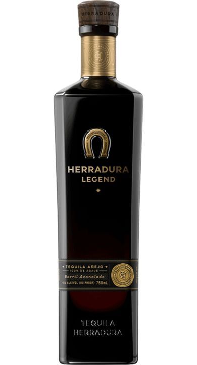 Herradura Legend tequila bottle, black with gold accents, horseshoe logo.