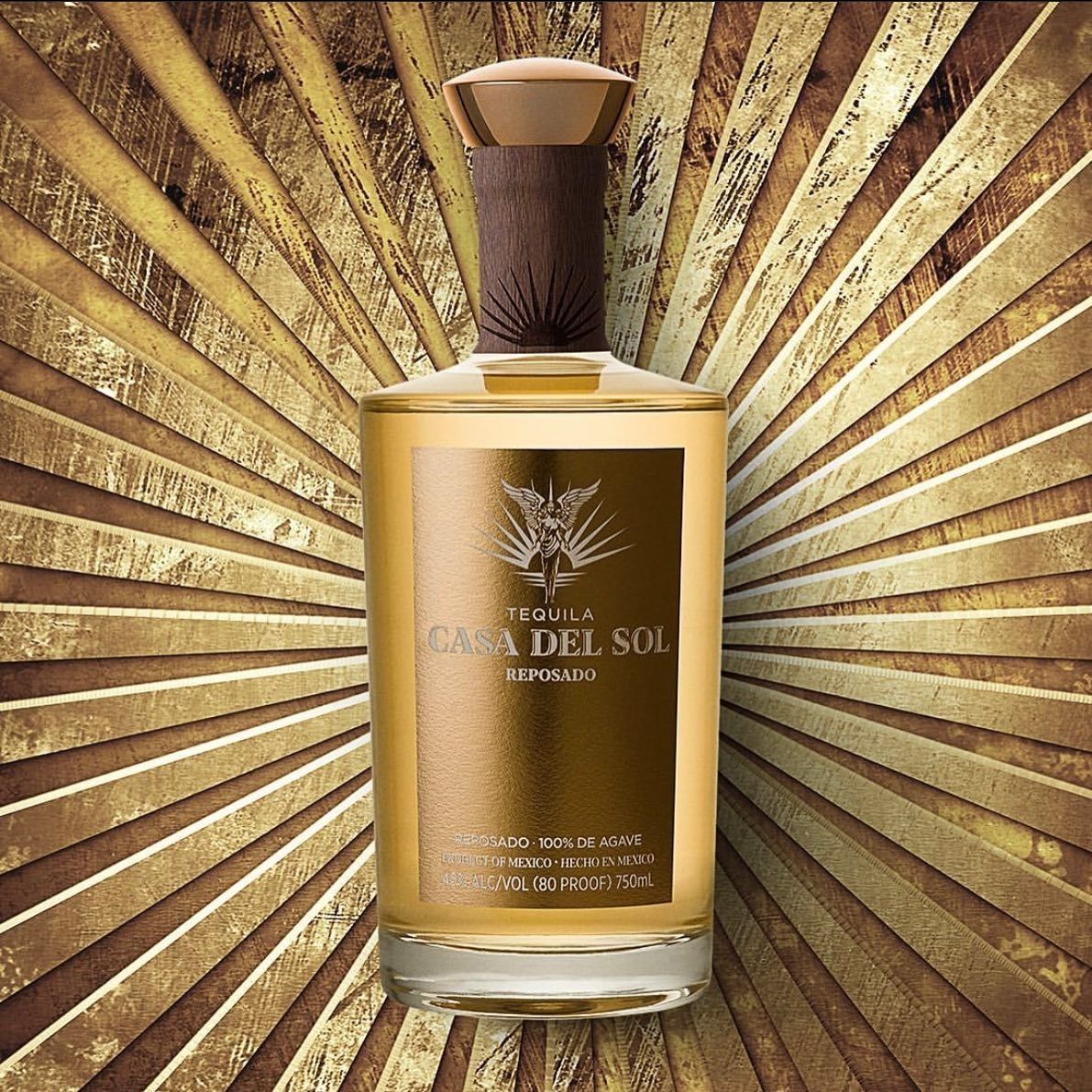 Bottle of Casa Del Sol tequila against a gold burst background.