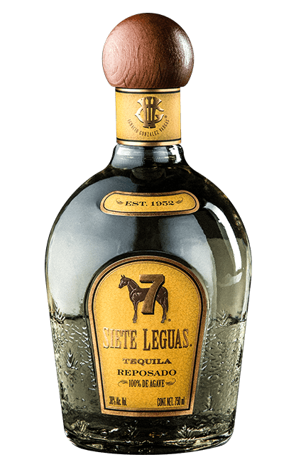 Bottle of Siete Leguas Reposado tequila with a wooden cap and a yellow label.