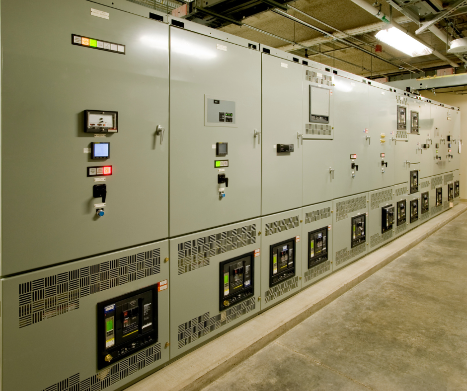 A row of electrical boxes are lined up in a room.