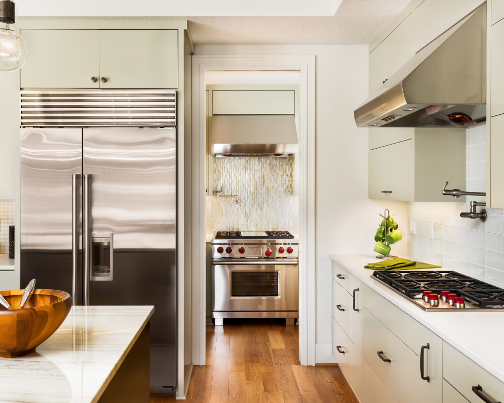 A kitchen with stainless steel appliances and white cabinets